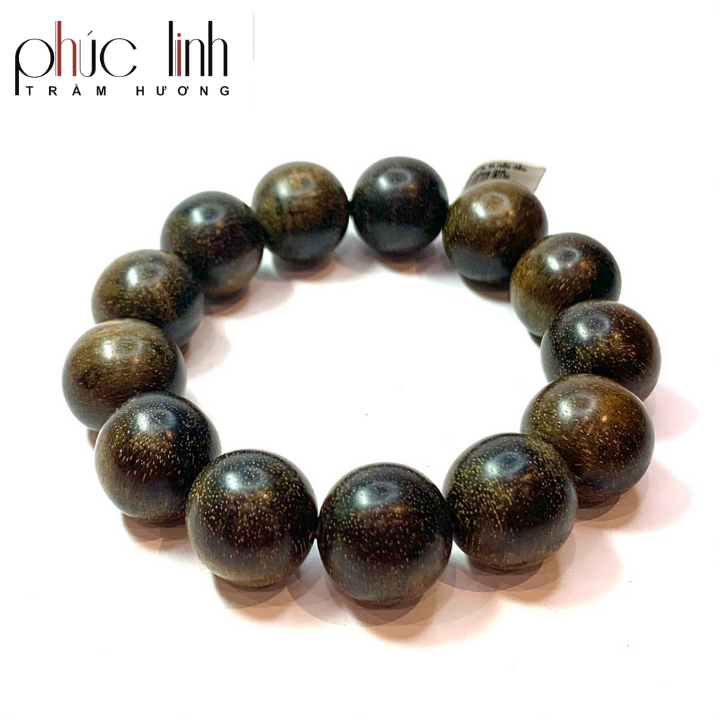 The Indonesian Agarwood bracelet with dark circular veins is rather substantial.